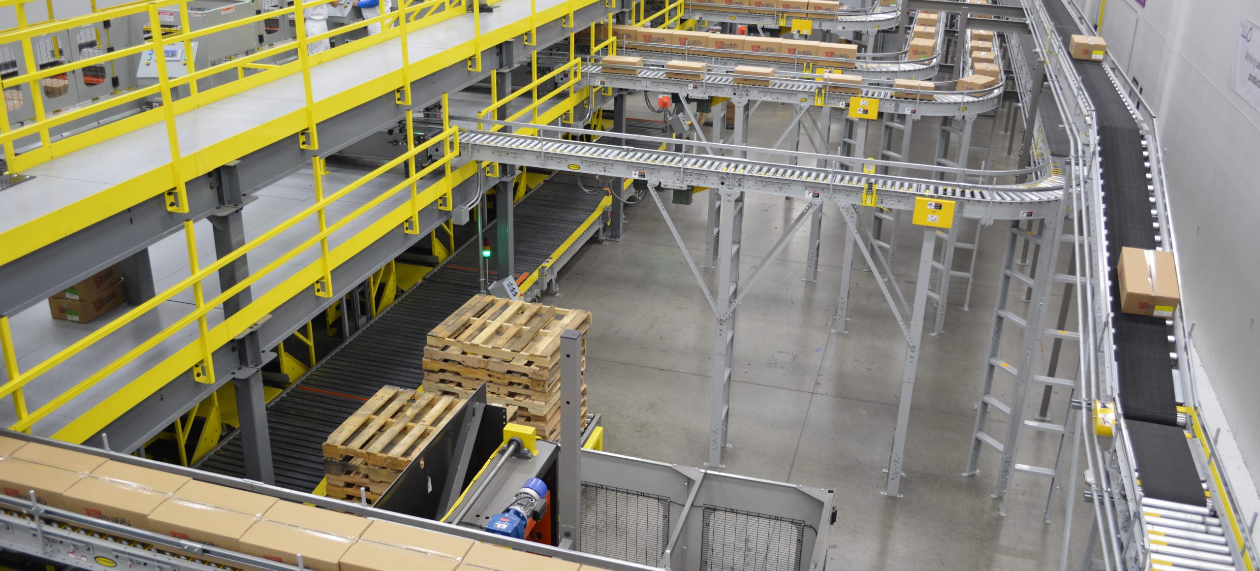 Image of multiple infeed conveyors moving product cases.
